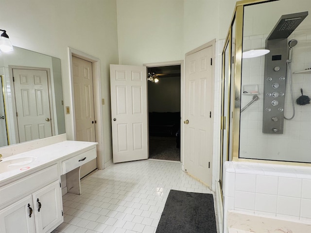 bathroom featuring tile patterned floors, vanity, ceiling fan, and a shower with door