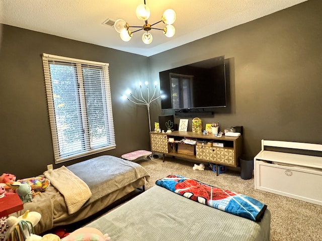 carpeted bedroom featuring a chandelier