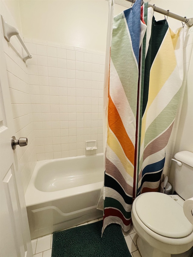 bathroom featuring tile patterned floors, toilet, and shower / bathtub combination with curtain