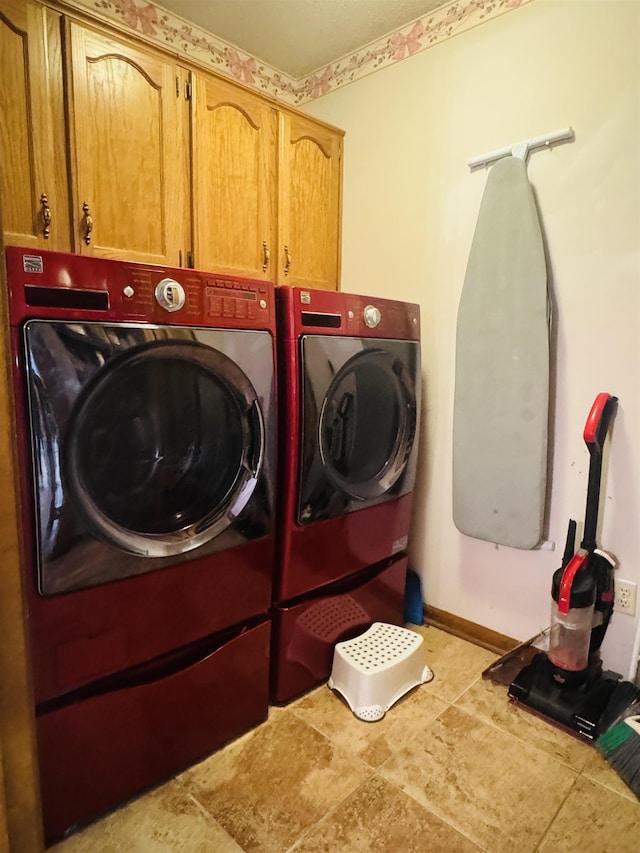 laundry room with cabinets and separate washer and dryer