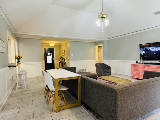 living room with light tile patterned floors, vaulted ceiling, and crown molding