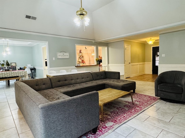 tiled living room with lofted ceiling, ceiling fan, and ornamental molding