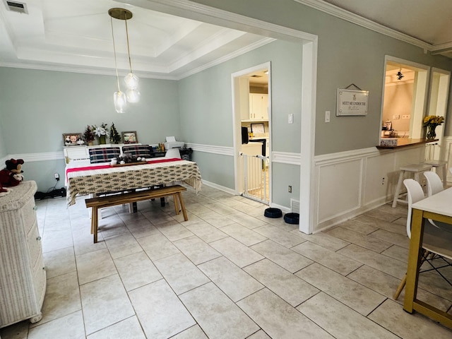 dining area featuring a raised ceiling and crown molding