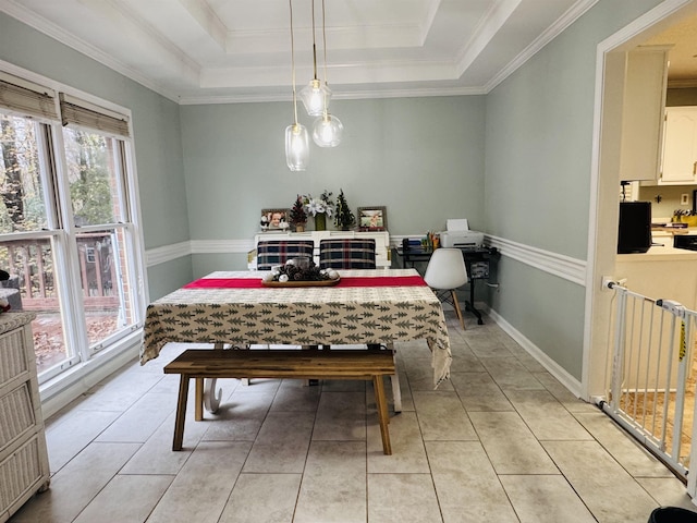 dining area featuring light tile patterned floors, a raised ceiling, and ornamental molding