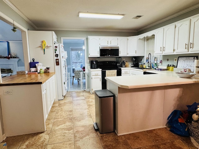 kitchen featuring kitchen peninsula, sink, white cabinets, white fridge, and black / electric stove