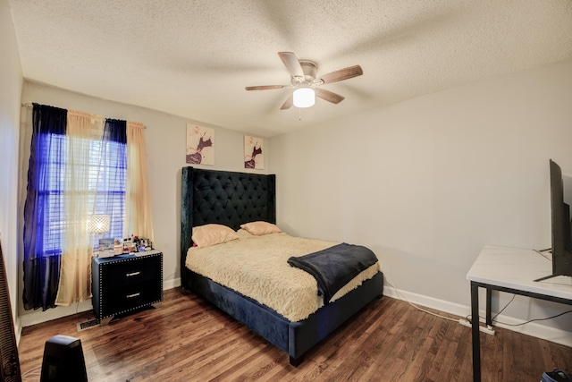 bedroom featuring ceiling fan, dark hardwood / wood-style flooring, and a textured ceiling