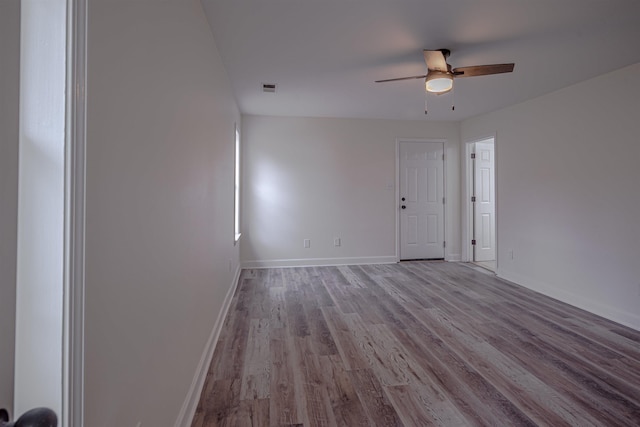 spare room with ceiling fan and light wood-type flooring