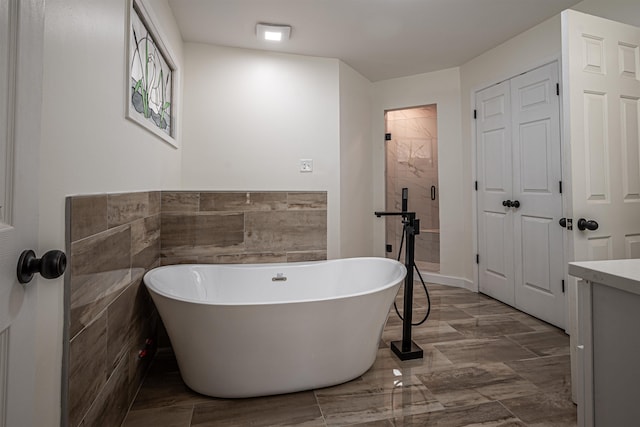 bathroom with vanity and a tub