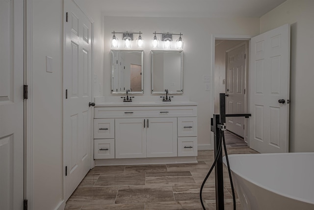 bathroom with a bath, vanity, and wood-type flooring