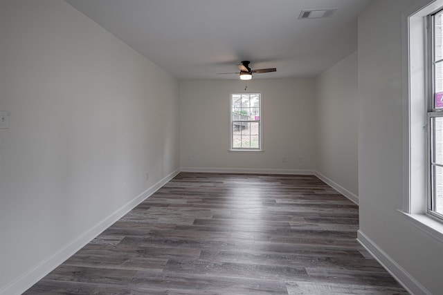 unfurnished room with dark hardwood / wood-style flooring and ceiling fan