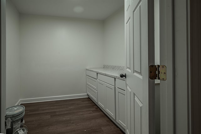 laundry area with dark hardwood / wood-style flooring