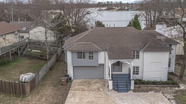 view of front of home with a water view and a garage