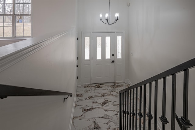 foyer with an inviting chandelier