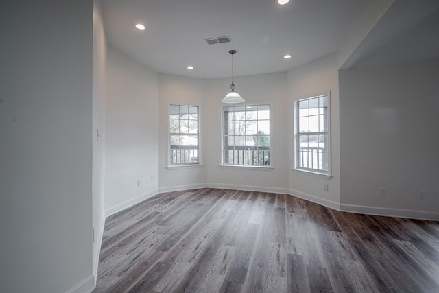 unfurnished dining area with dark hardwood / wood-style flooring