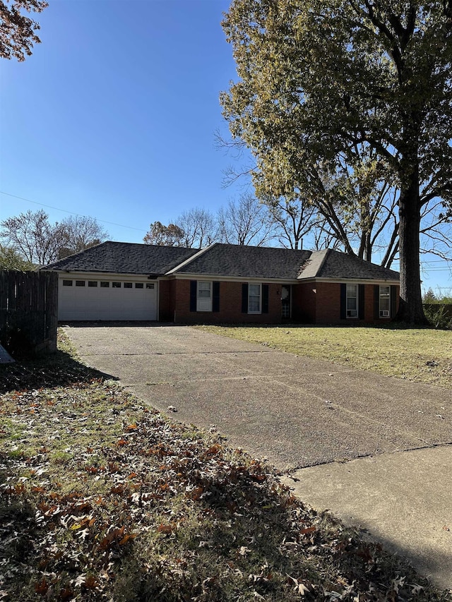 single story home featuring a front yard and a garage