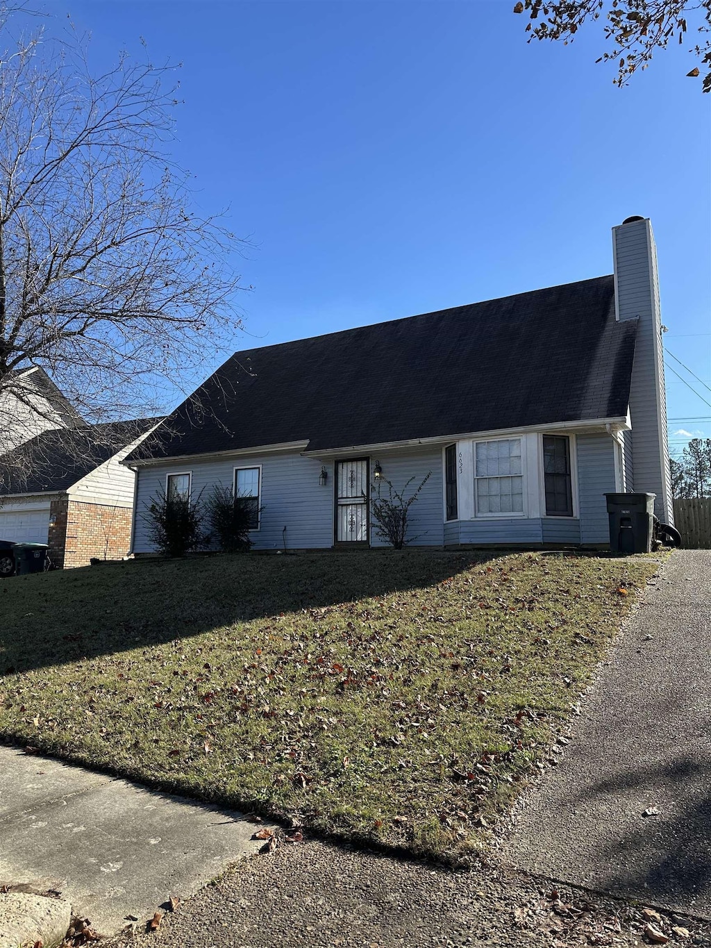 view of side of property with a lawn