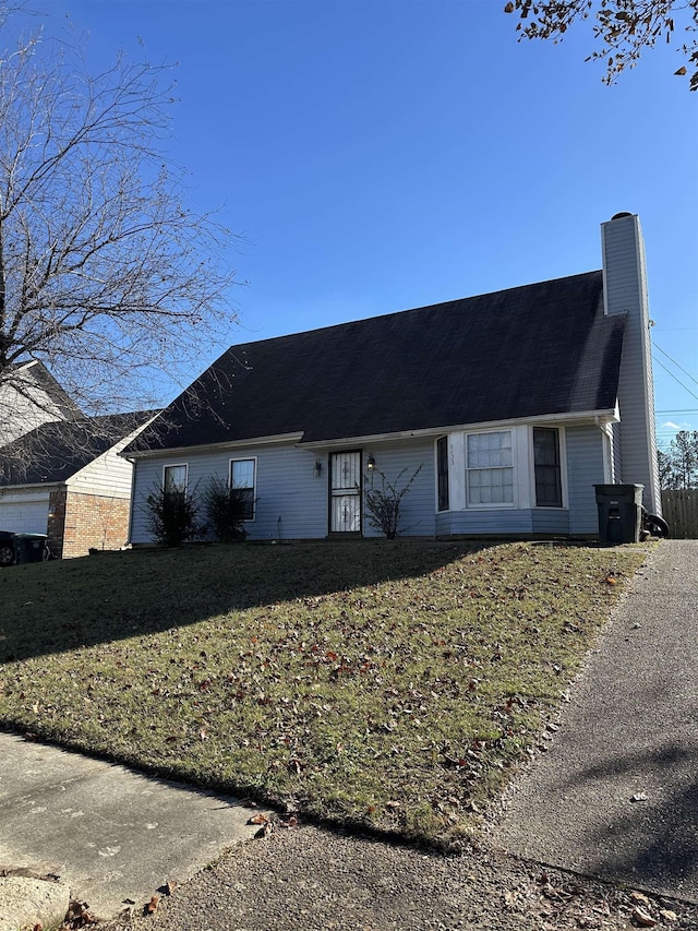 view of side of property with a lawn