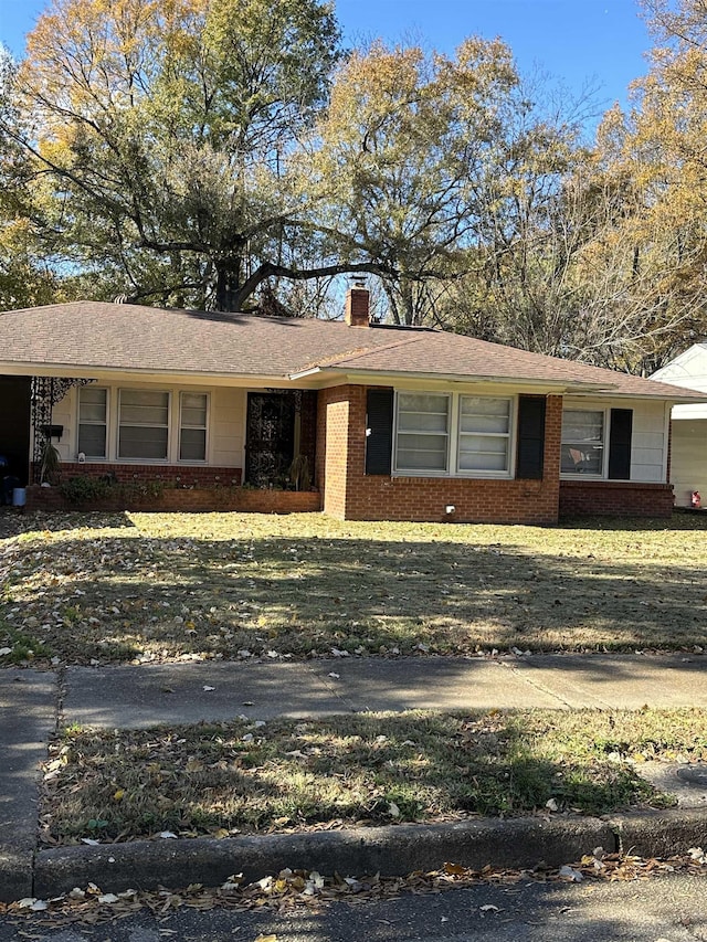 ranch-style home featuring a front yard