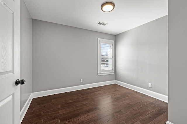 spare room with dark hardwood / wood-style floors