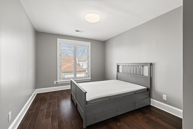 unfurnished bedroom with dark hardwood / wood-style flooring