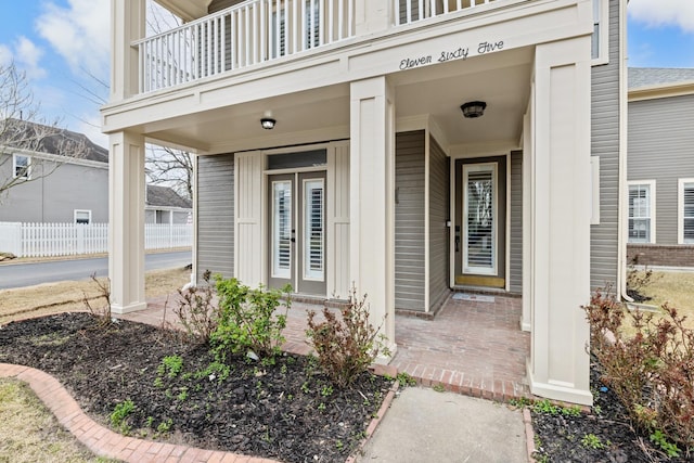 view of exterior entry with a balcony