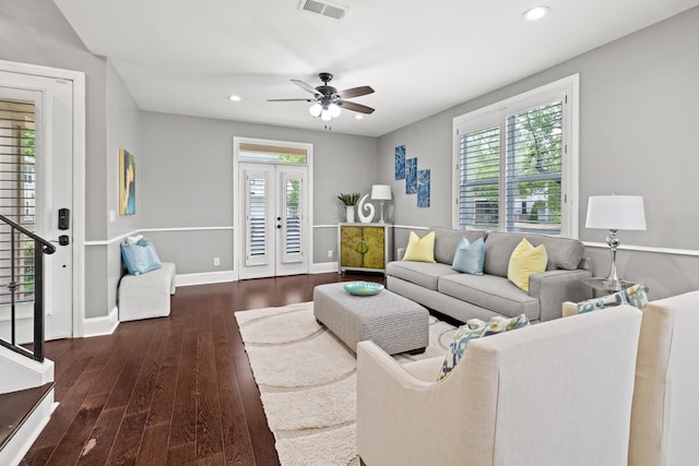 living room featuring dark hardwood / wood-style floors, ceiling fan, a wealth of natural light, and french doors