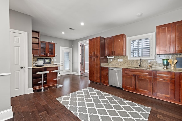 kitchen featuring backsplash, sink, and stainless steel dishwasher