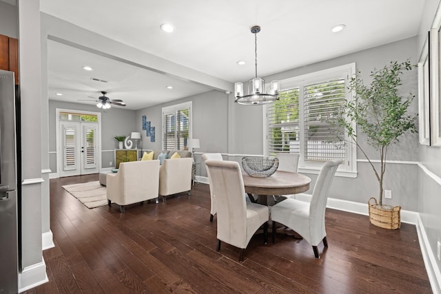 dining area with ceiling fan with notable chandelier and dark wood-type flooring