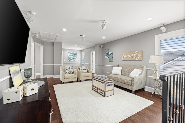 living room featuring a healthy amount of sunlight and dark wood-type flooring