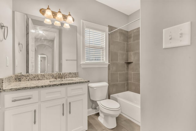 full bathroom with vanity, toilet, and tiled shower / bath