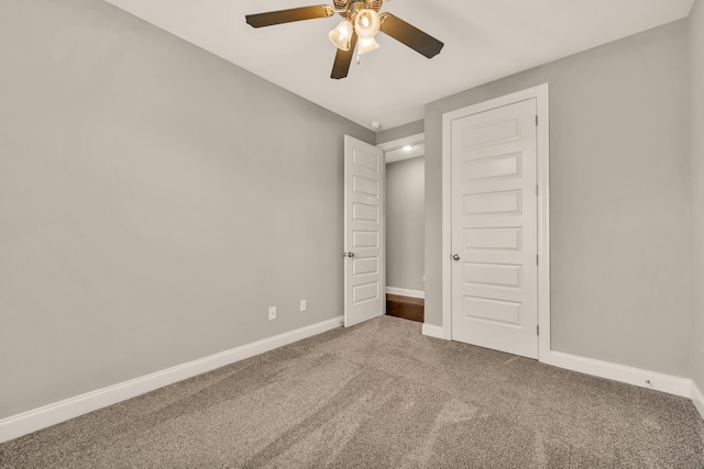 unfurnished bedroom featuring carpet floors, a closet, and ceiling fan