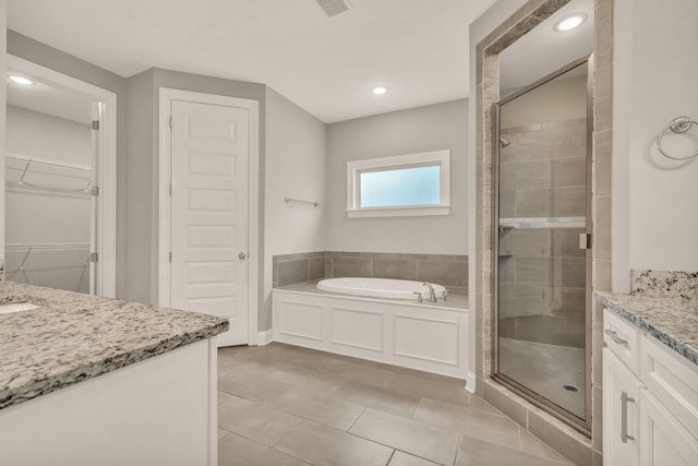 bathroom featuring vanity, tile patterned floors, and separate shower and tub