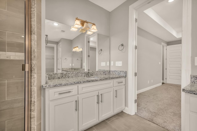 bathroom featuring vanity and an enclosed shower