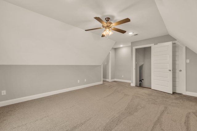 additional living space with ceiling fan, carpet floors, and vaulted ceiling