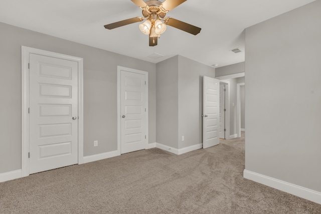 unfurnished bedroom featuring ceiling fan and light colored carpet