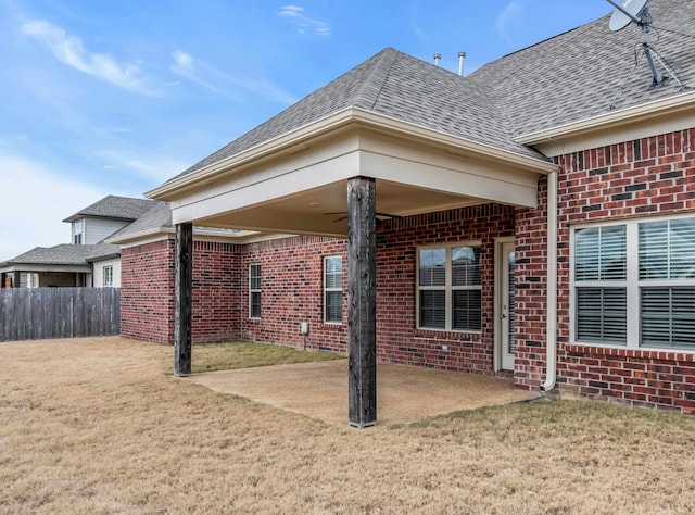 rear view of house with a patio area, ceiling fan, and a yard