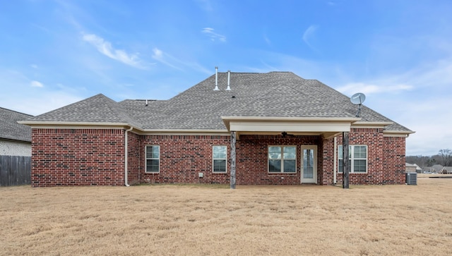 back of house featuring central AC, ceiling fan, and a lawn