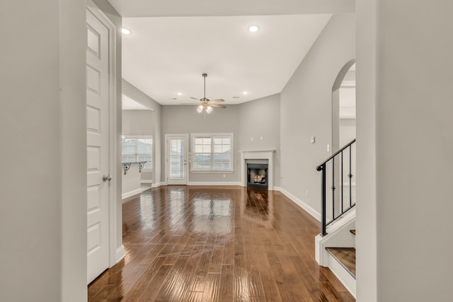 unfurnished living room featuring ceiling fan and wood-type flooring