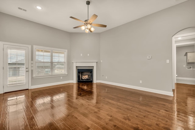 unfurnished living room featuring wood-type flooring and ceiling fan