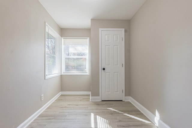 empty room with light hardwood / wood-style flooring