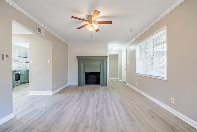 unfurnished living room featuring crown molding, ceiling fan, a fireplace, and light hardwood / wood-style floors