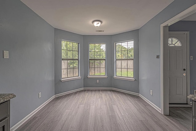 unfurnished dining area featuring light hardwood / wood-style floors