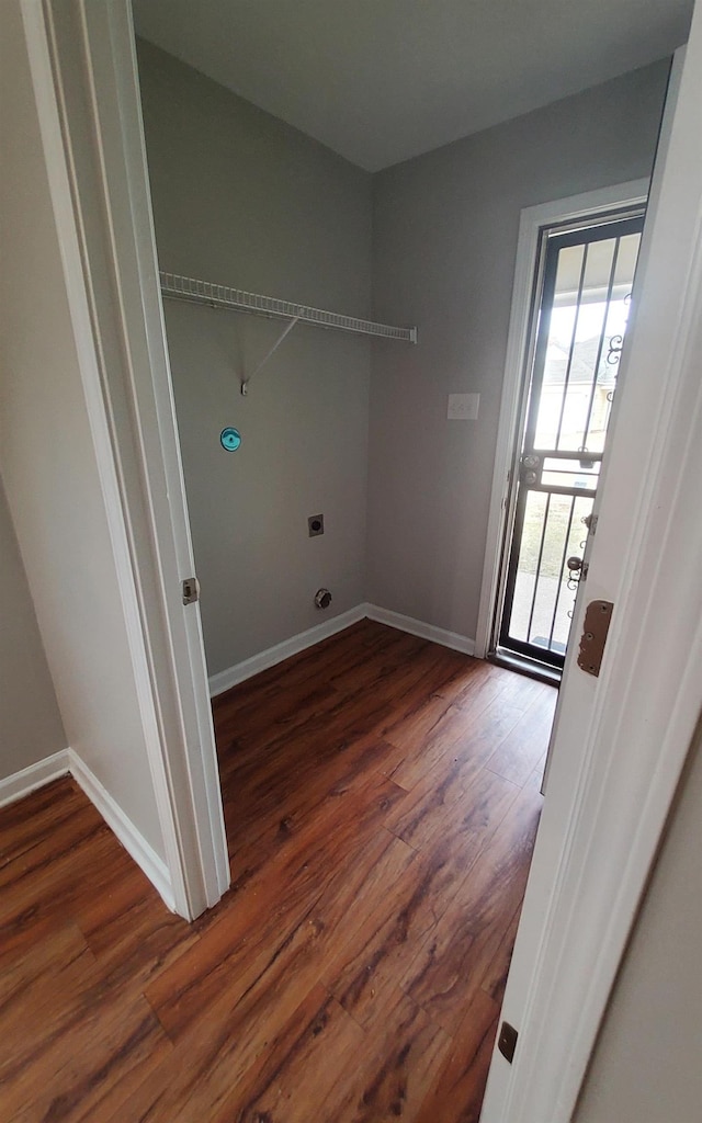 washroom featuring dark wood-type flooring and electric dryer hookup