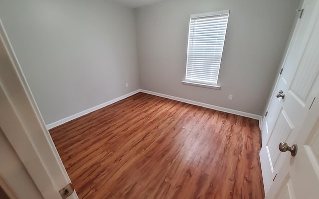 empty room featuring hardwood / wood-style flooring and plenty of natural light