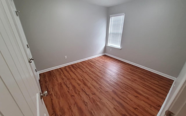 unfurnished room with hardwood / wood-style flooring