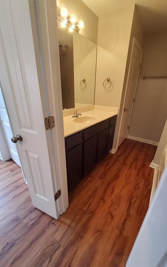 bathroom featuring vanity and wood-type flooring