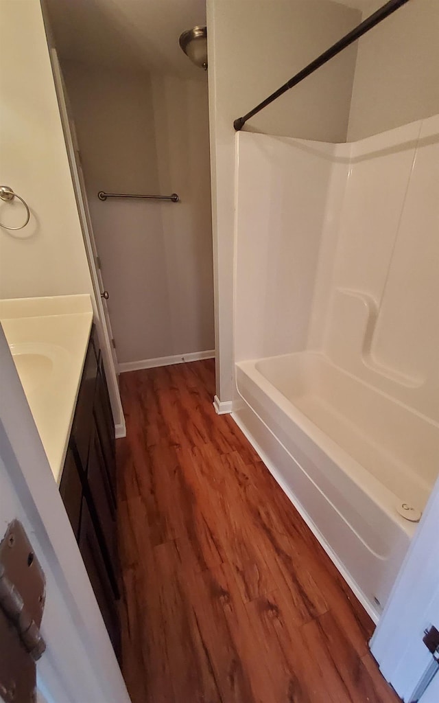 bathroom featuring vanity, shower / bathtub combination, and hardwood / wood-style flooring