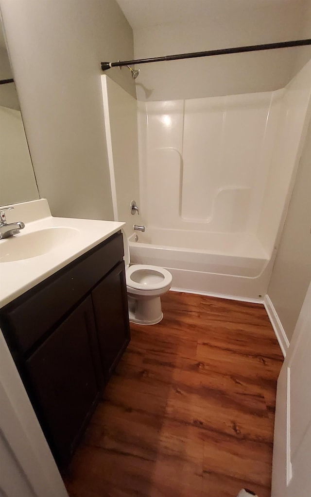 full bathroom with vanity, toilet, wood-type flooring, and tub / shower combination