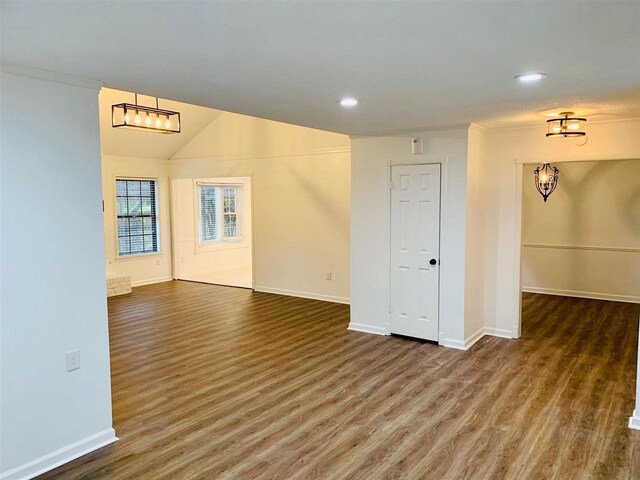 spare room featuring dark hardwood / wood-style floors and ornamental molding