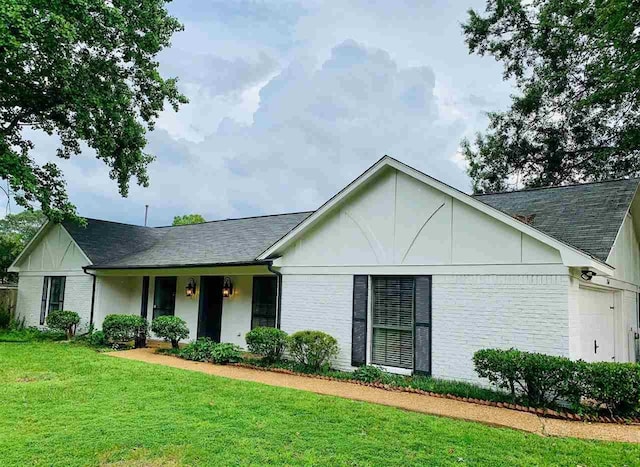 ranch-style home featuring a garage and a front lawn